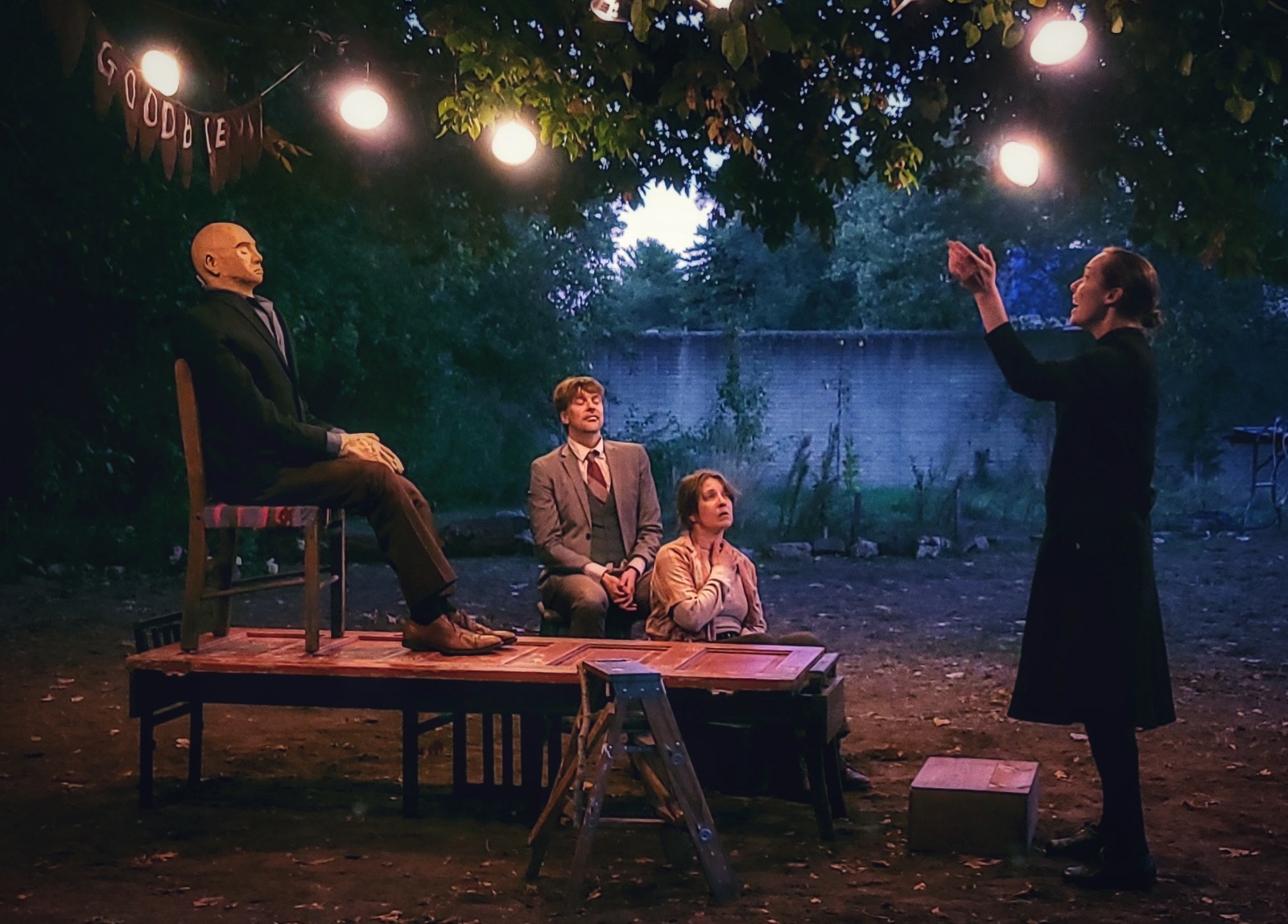 “Will You Miss Me at Tympanum (film still by Adam Sekuler)” - (from left to right) Preacher (Richard Newman), Remy (Jenna Kirk), and Faith (Liza Bielby) honor Blaine with a song in the wake. 